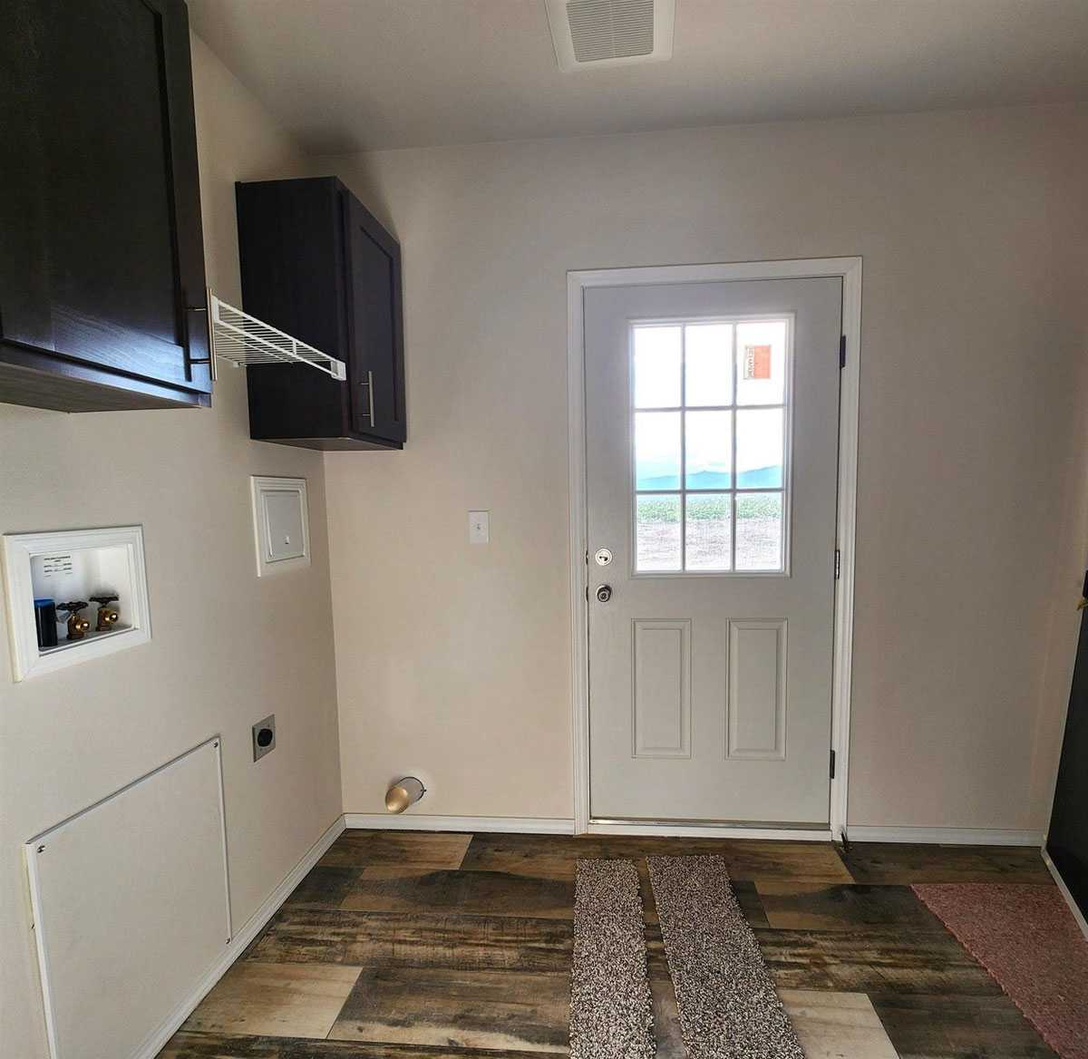 Laundry room with storage in 28664E The Rapids