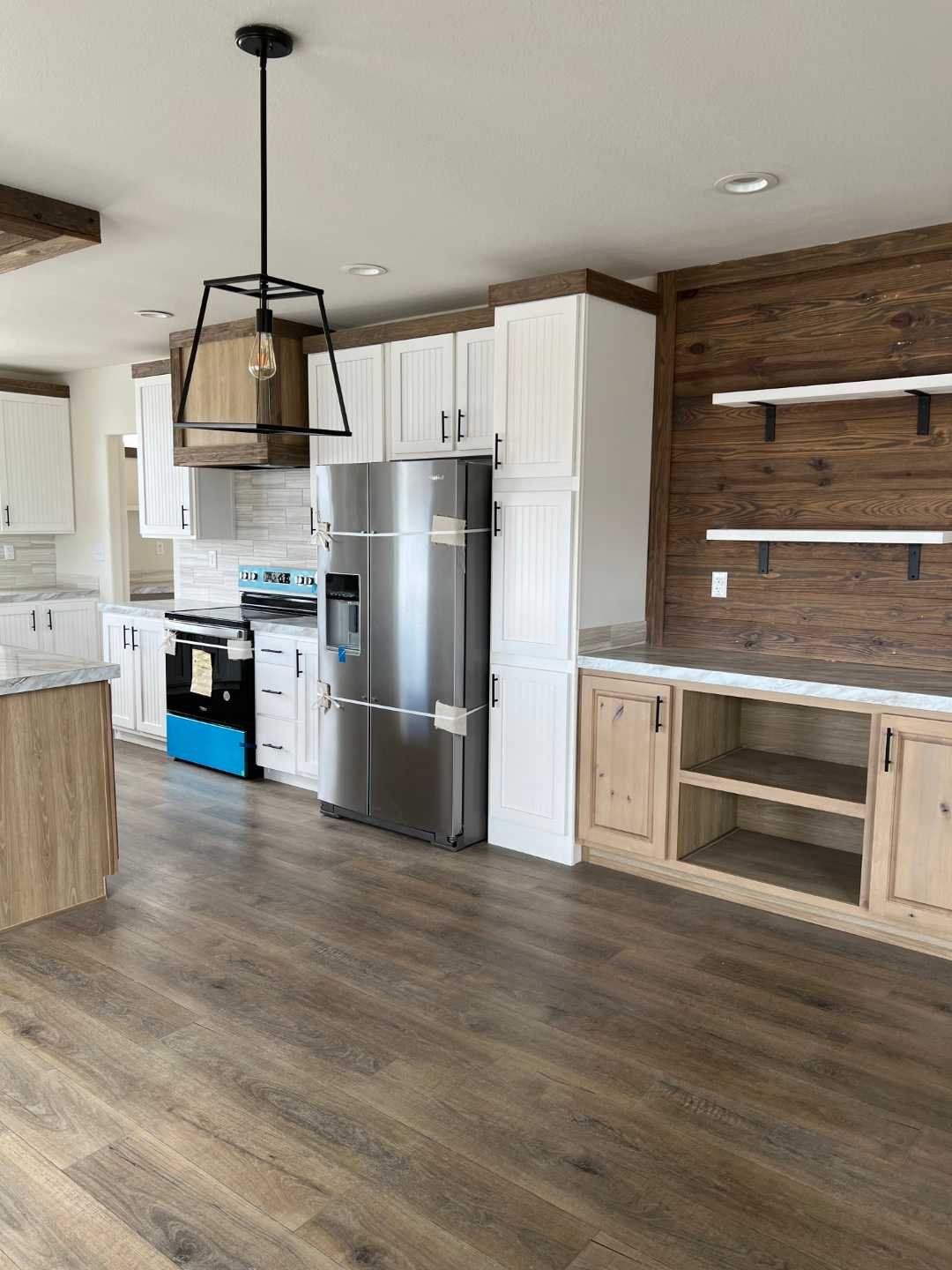 Dining room with elegant chandelier in The Clover by Fleetwood Homes