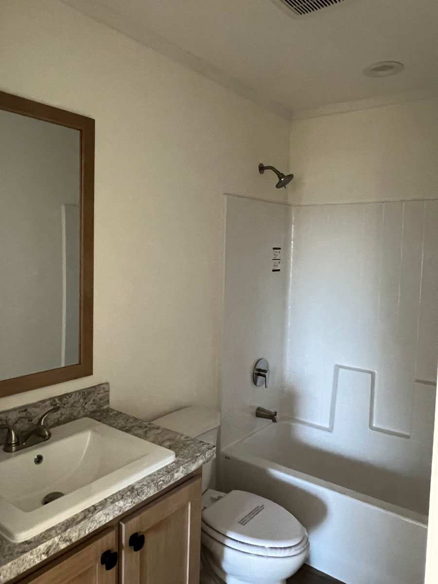 Lovely second bath with china sinks and one-piece tub shower in Here Comes the Sun