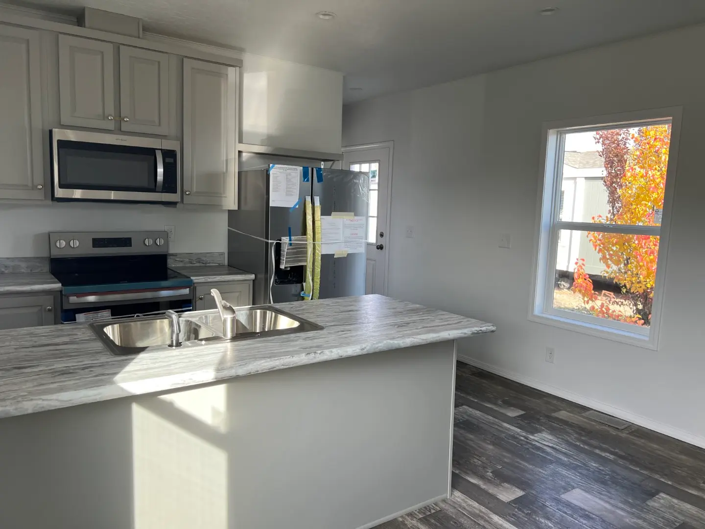 Kitchen with Large windows in this Champion Singlewide Home