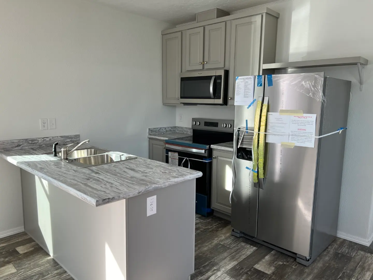 Large fridge and modern appliances in this Affordable Home