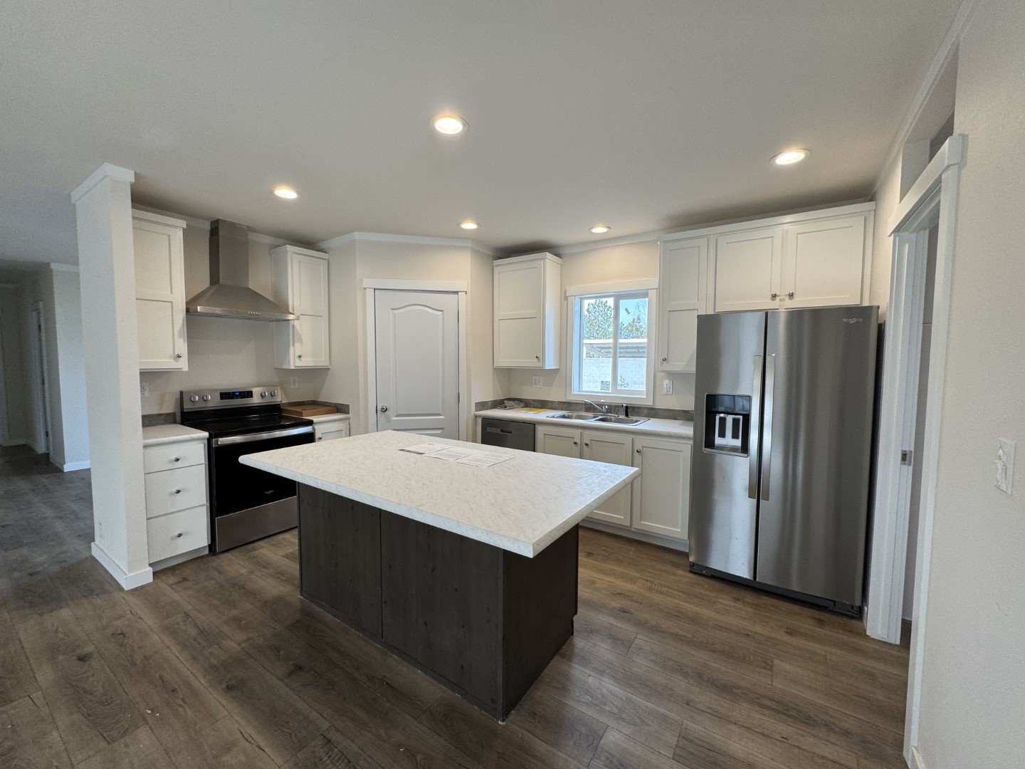 Modern kitchen with island and appliances in Cavco Rhythm 28664R manufactured home