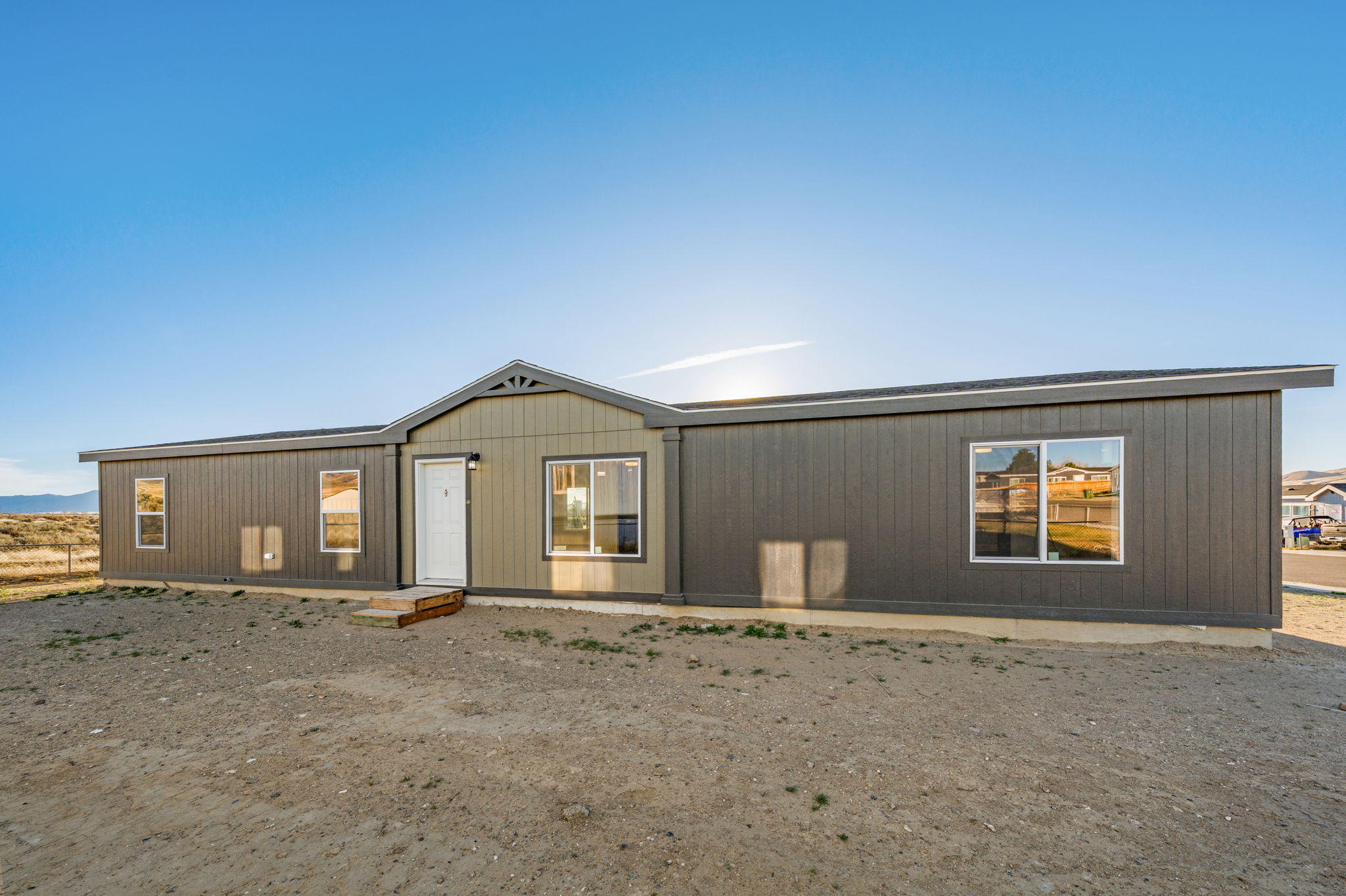 Front exterior of Cavco 28664R Stretch manufactured home showcasing entry and curb appeal
