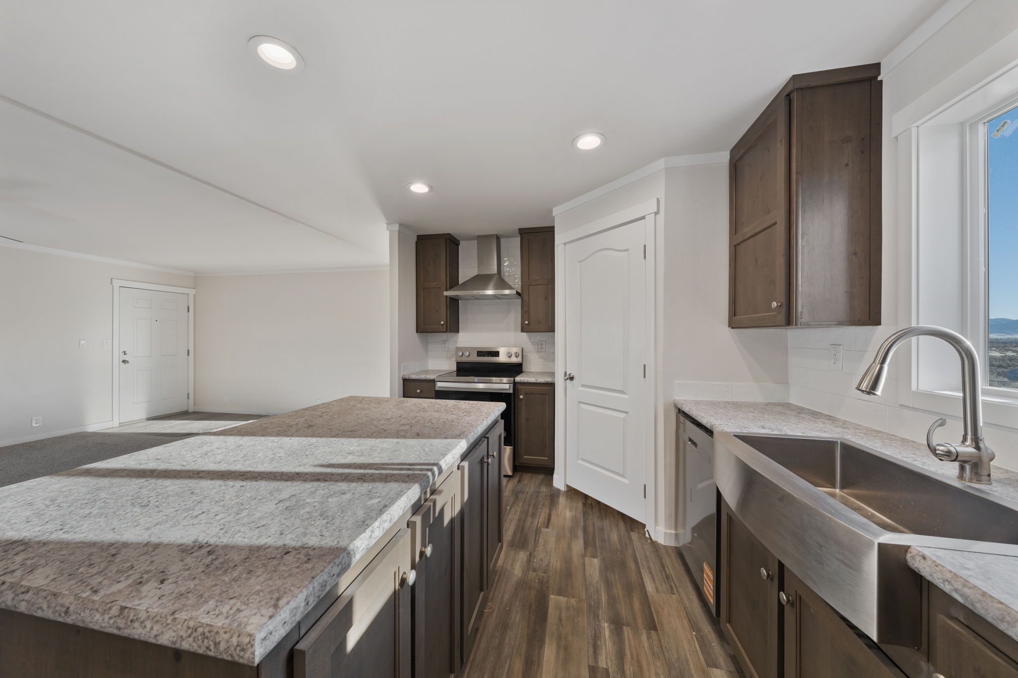 Spacious kitchen and dining area in Cavco Rhythm 28664R open floor plan home